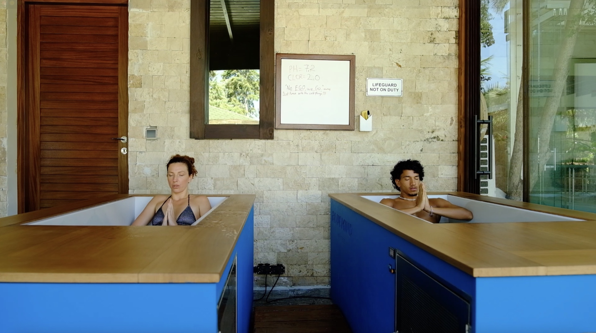 Woman relaxing by the pool with green juice at TheLifeCo Bodrum