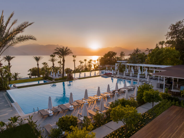 Aerial view of the pool at TheLifeCo Antalya overlooking the sea at sunset