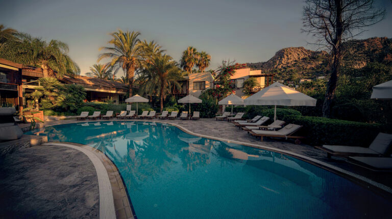 The pool and gardens of TheLifeCo Bodrum at sunset